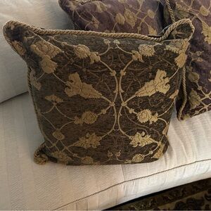 Three brocade pillows -